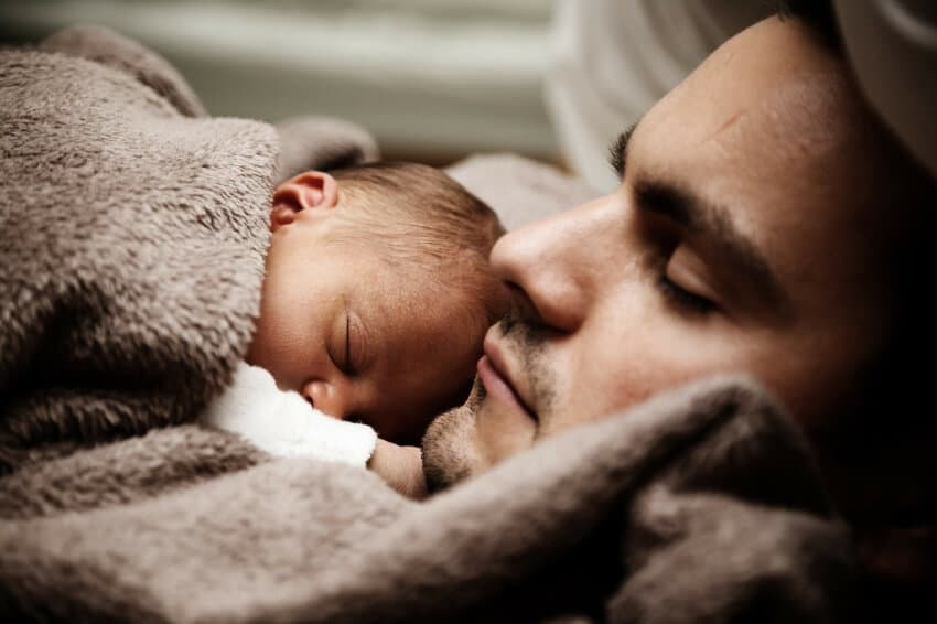 man sleeping with baby