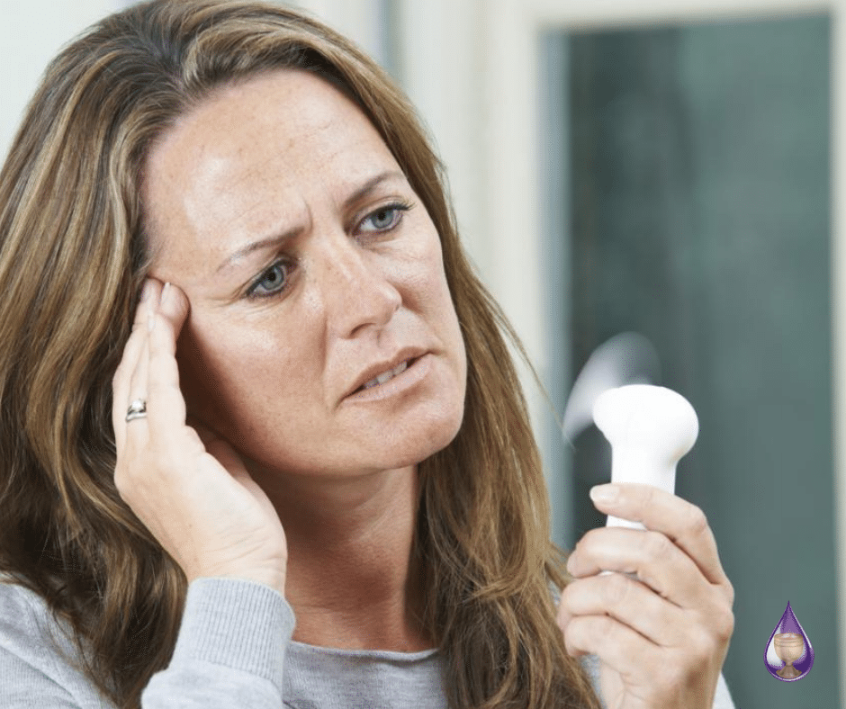 Woman Holding Fan Cooling Off